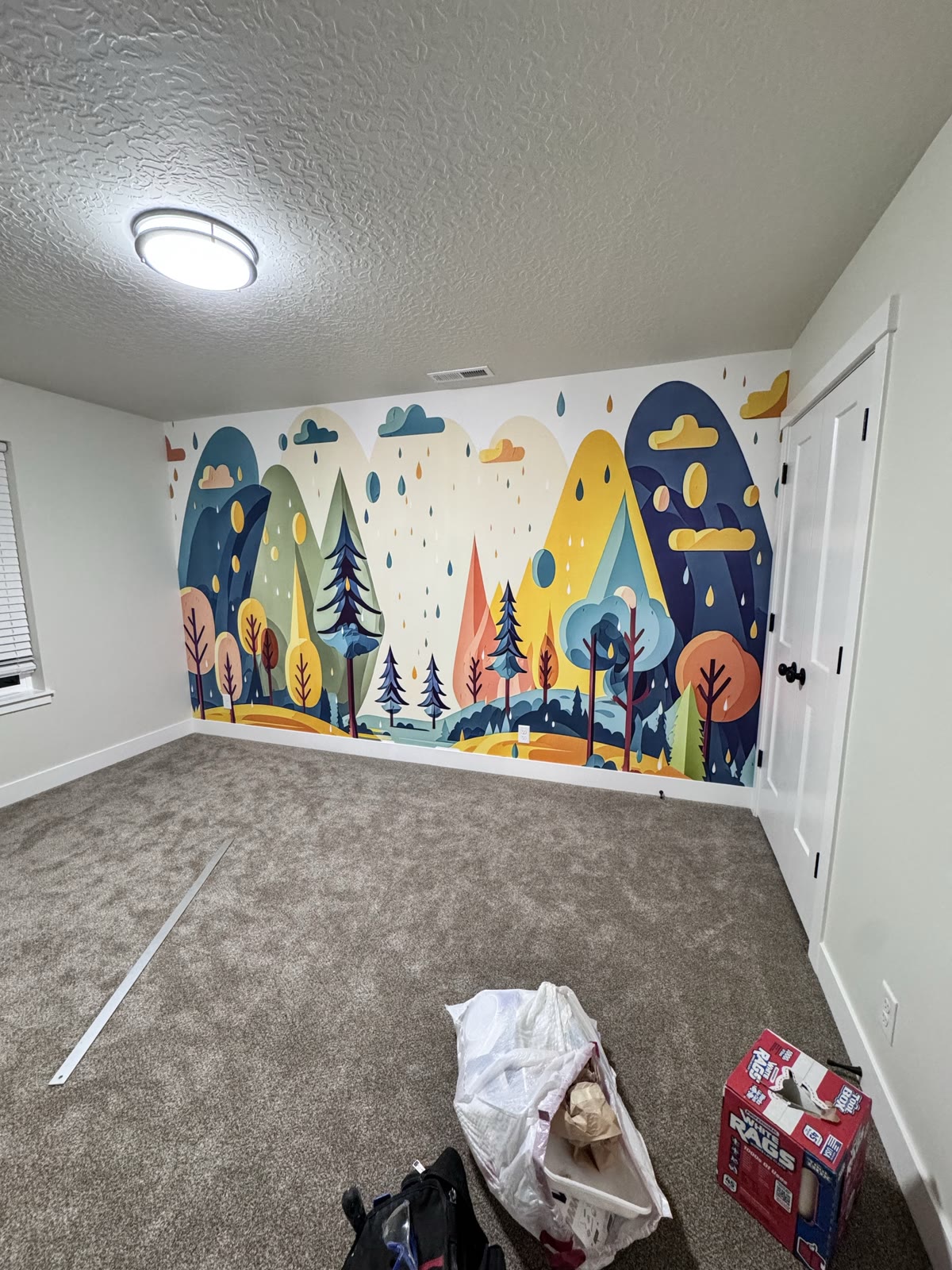 Finished colorful landscape-scene wallpaper mural on a room wall