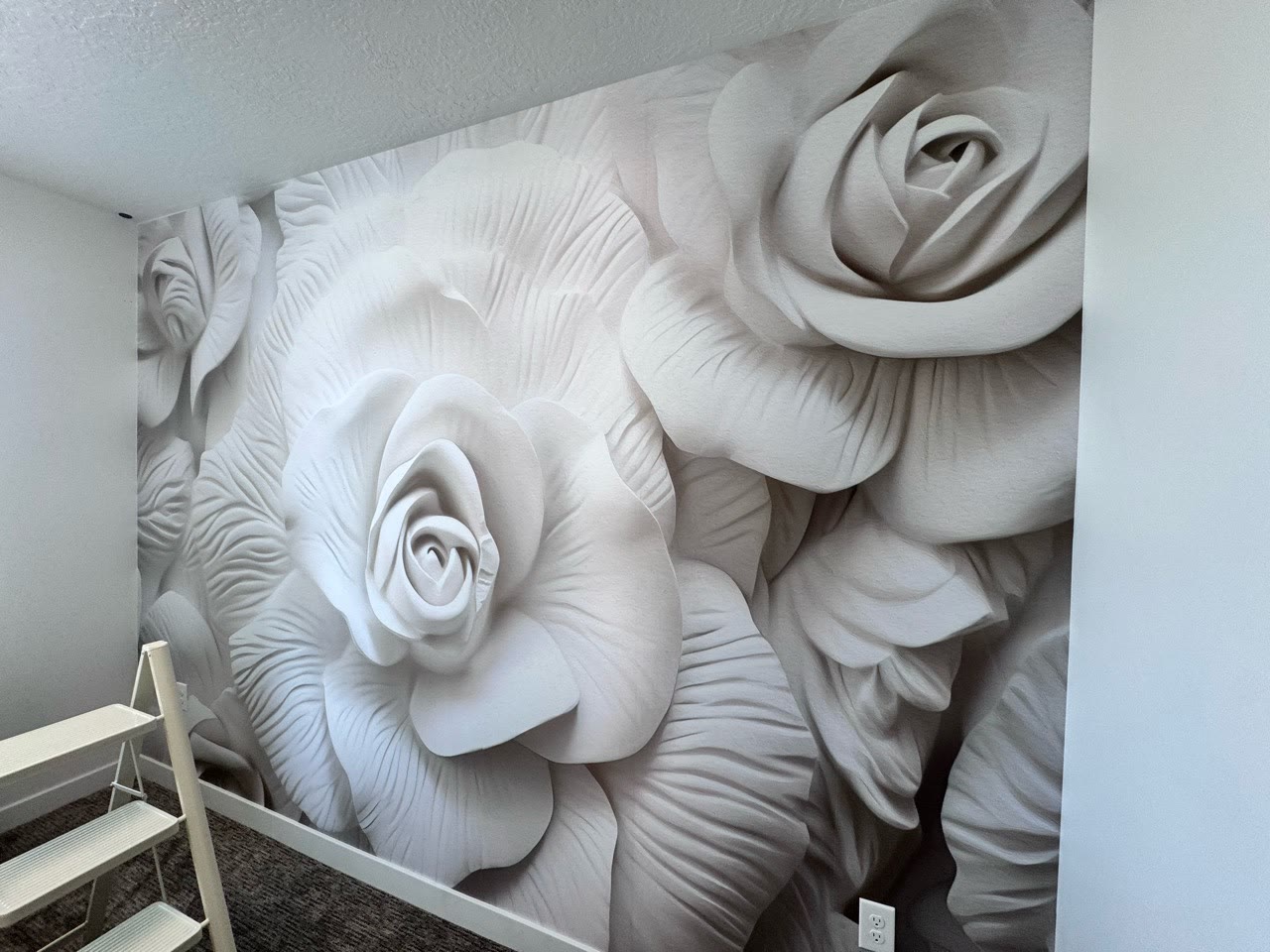 Oversized three-dimensional floral mural installed on a room wall