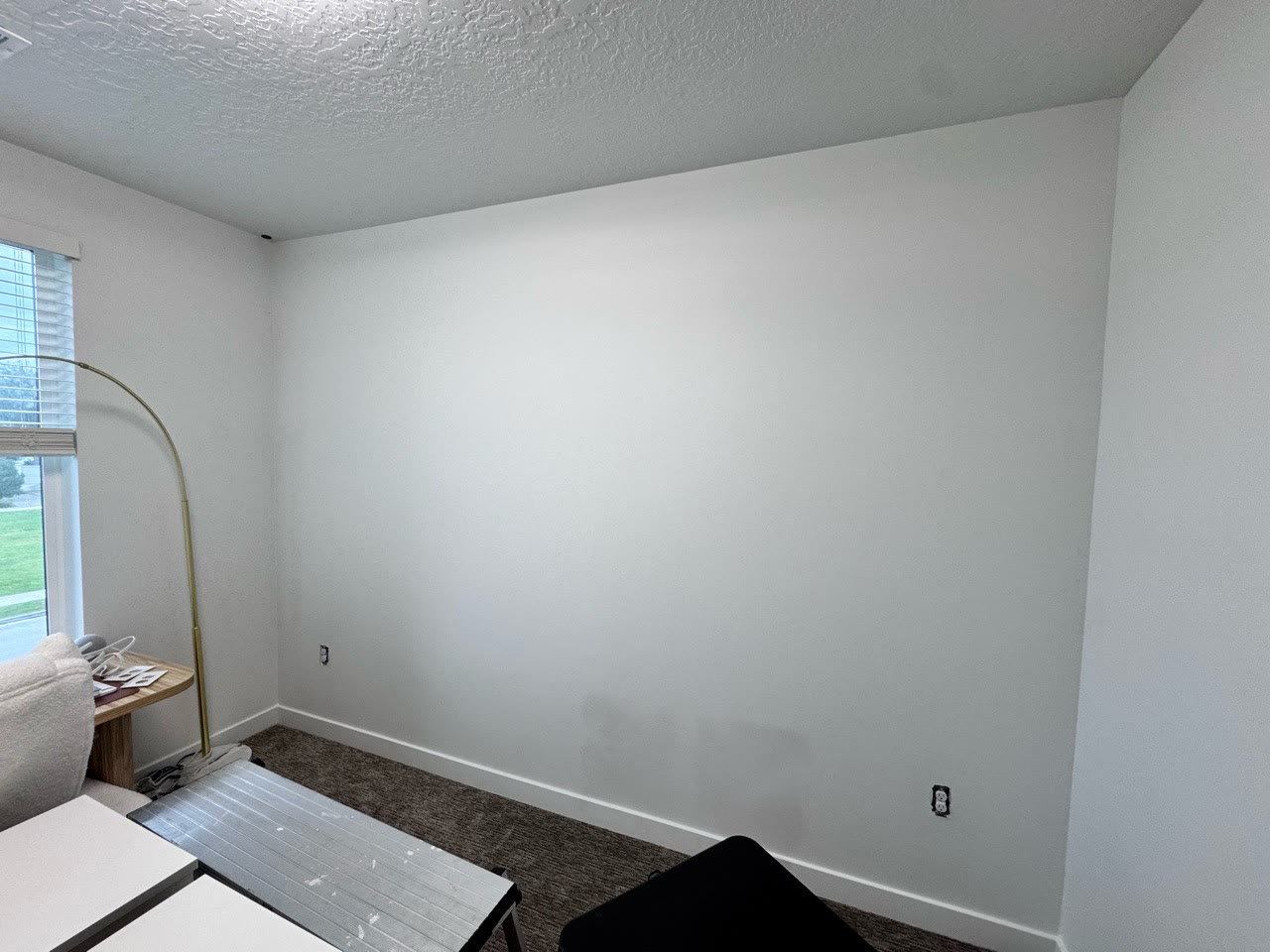 Plain room wall before a floral mural installation