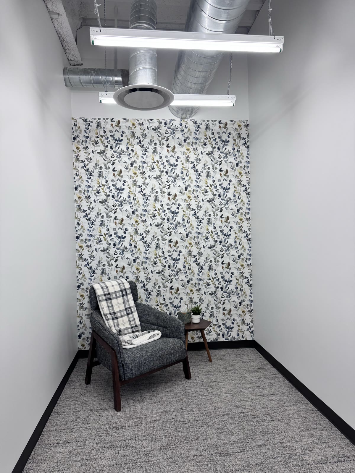 Finished wallpaper and accent trim in a Draper corporate-office mother's room