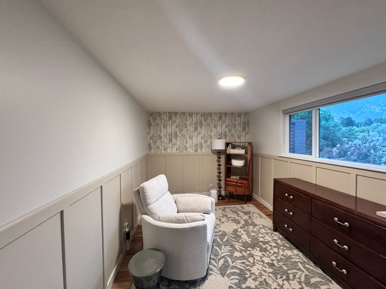 Nursery with wallpaper added above the accent trim